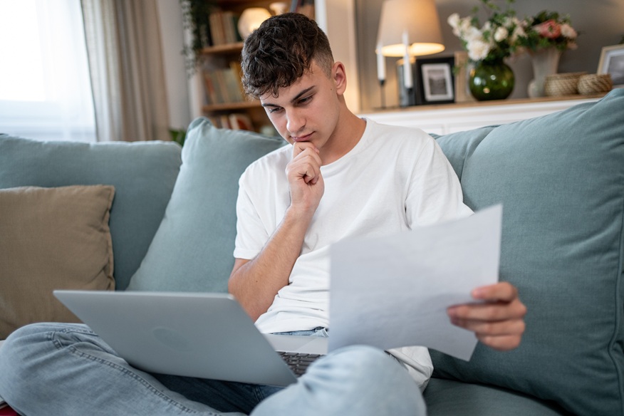 Young person reviewing student finance documents at home